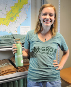 Candace Lee Mullins, ’13 shows off a few items used to promote Grow Appalachia.