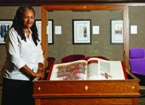 Reverend Gail Bowman with the SJB in a case created by Berea College craftsperson Chester Mullins.