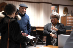 Sharyn Mitchell speaks with visitors to the archives