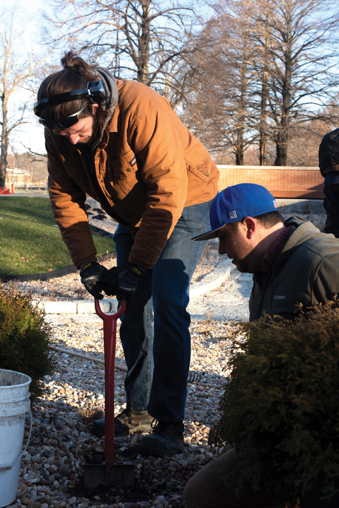 Grounds crew student and supervisor install new plants