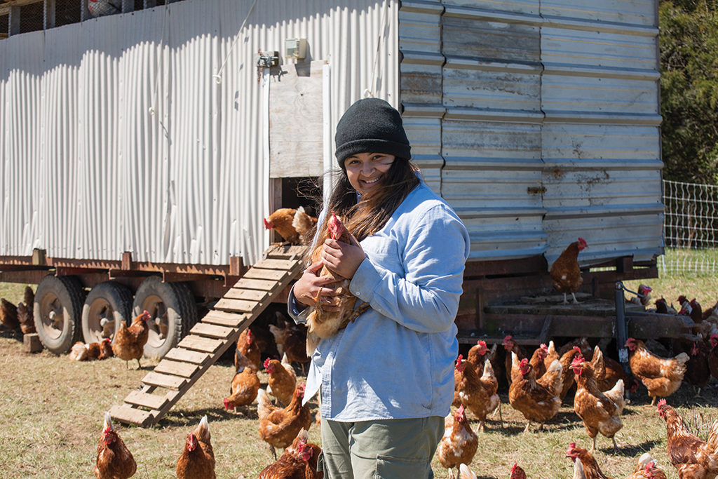 Student Anahi Favela holds a chicken