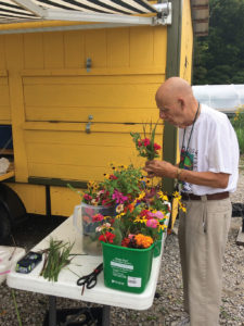 Jerry Workman arranges flowers and herbs