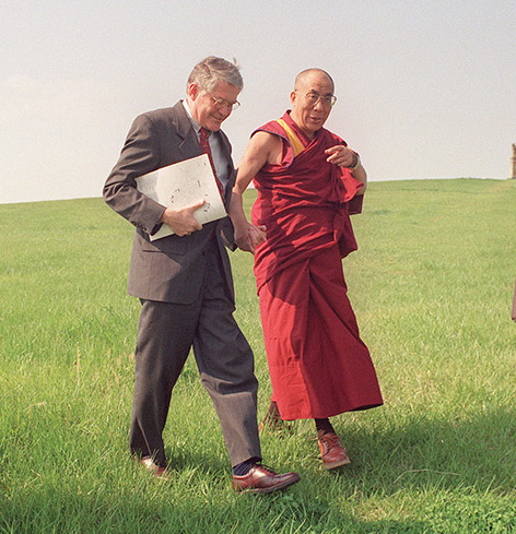 President John Stephenson holds hands with Dalai Lama