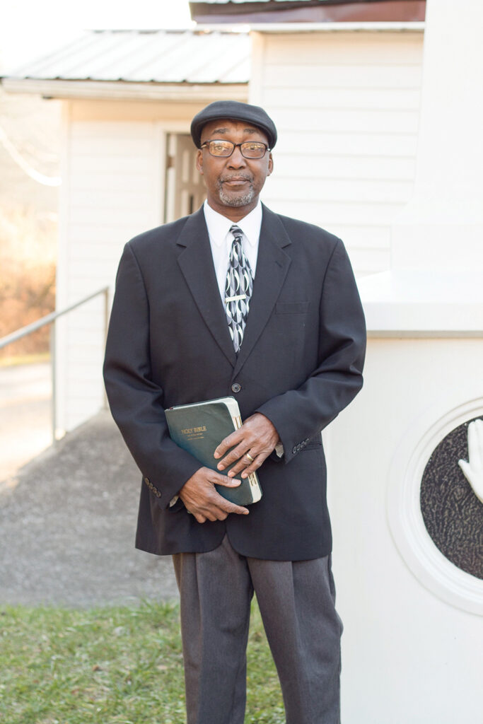 Reverend Steve Peake holding a bible