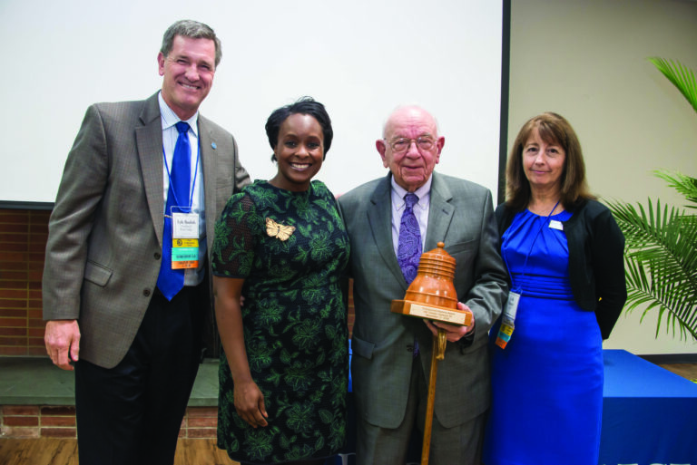 Alumni Award, pictures of President Dr. Lyle D. Roelofs, Dr. Charles Haywood and two women
