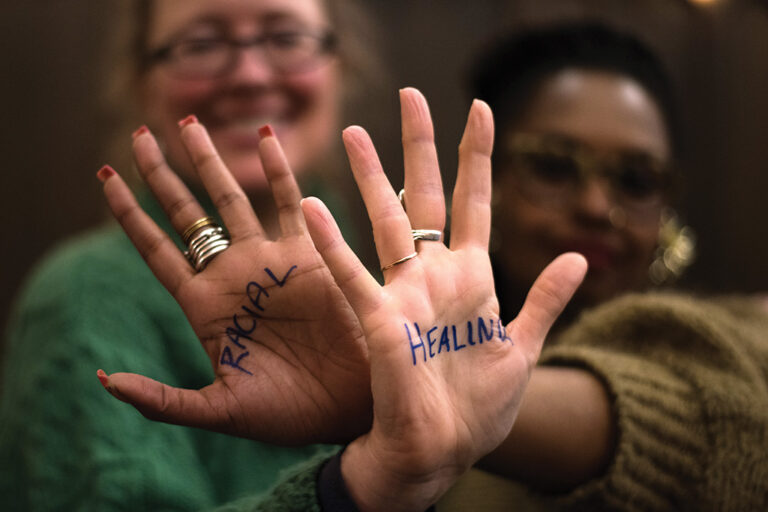 The words racial healing written on professors' hands