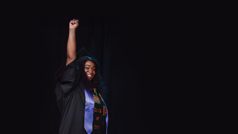 Berea graduate raising her fist to the air