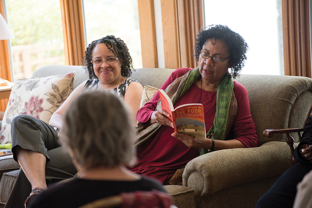 bell hooks reading a book at a group gathering