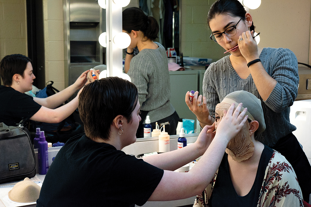 Students applying makeup for a theater production