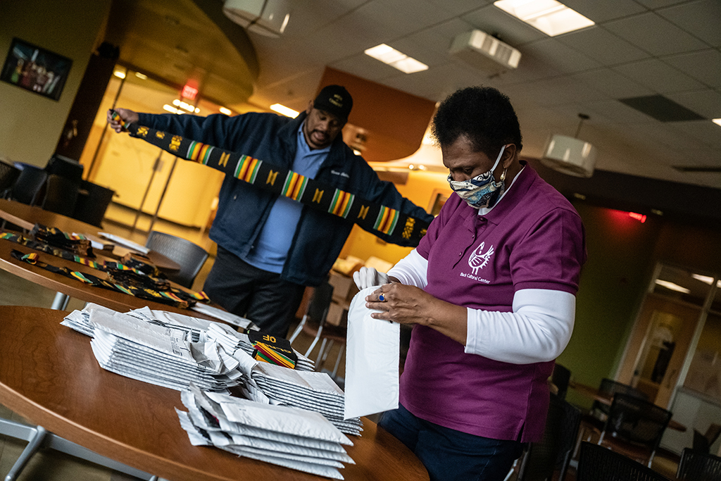 Keith Bullock and Valeria Watkins pack stoles to mail to students