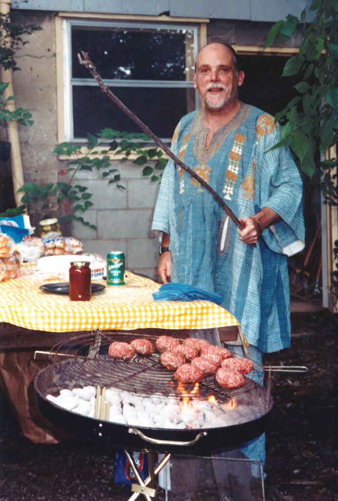 Dr. Tom Boyd grills hamburgers for a cookout at his home.
