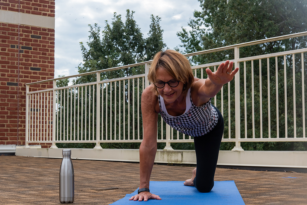 Counselor Sue Reimondo leading a yoga class on the roof of Dana Residence Hall