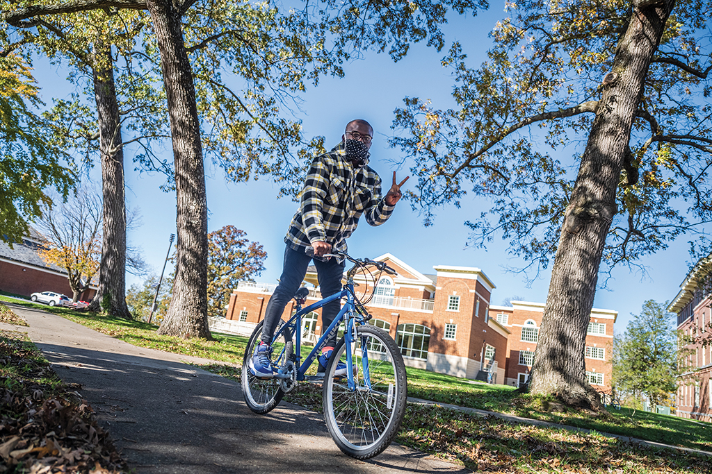 Obinna Ilochonwu riding his bike on Berea's campus