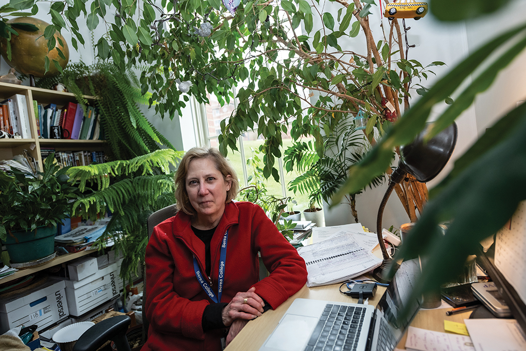 Dr. Dawn Anderson surrounded by her office plant collection