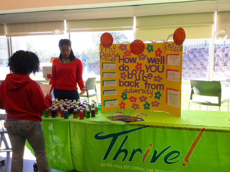 Student works a Thrive event table