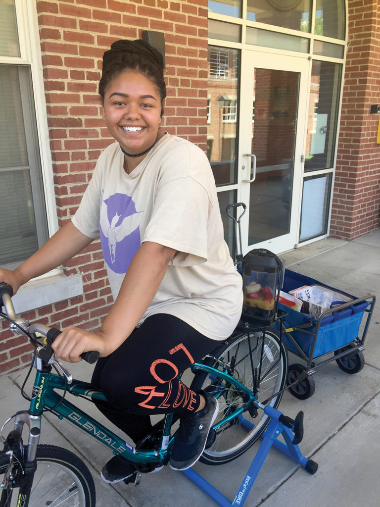 Student rides a bike attached to a smoothie maker