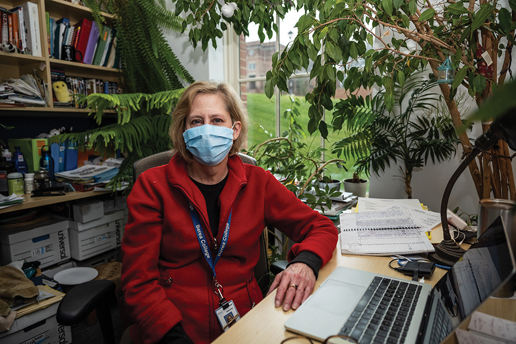 Dr. Dawn Anderson sitting at her desk wearing a mask