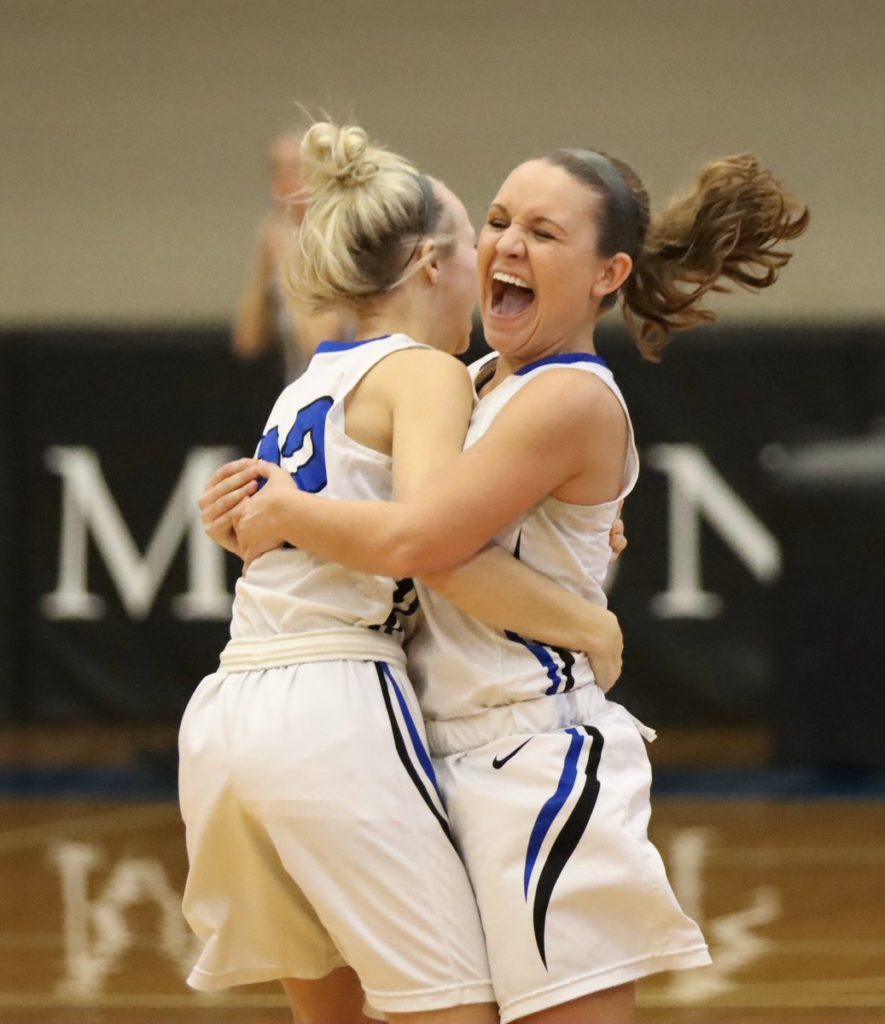 Bailee hugs a teammate celebrating a conference tournament win