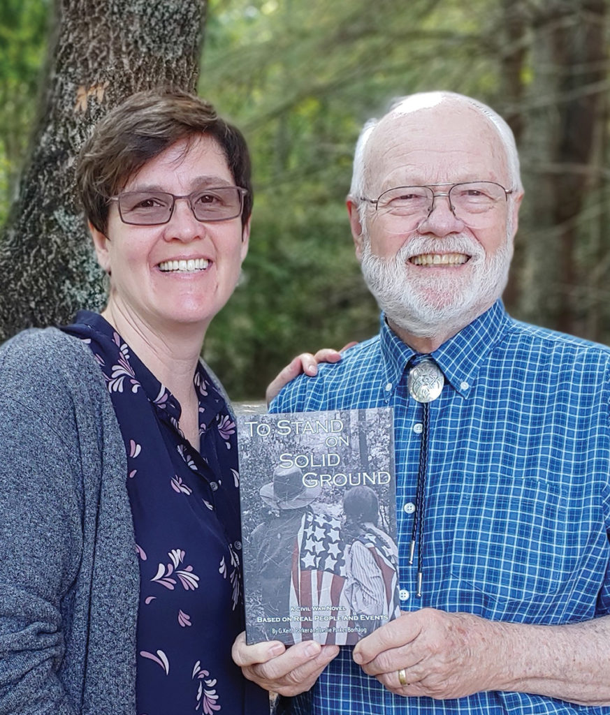 Portrait of Leslie P Borhaug and G Keith Parker holding the book they co-authored