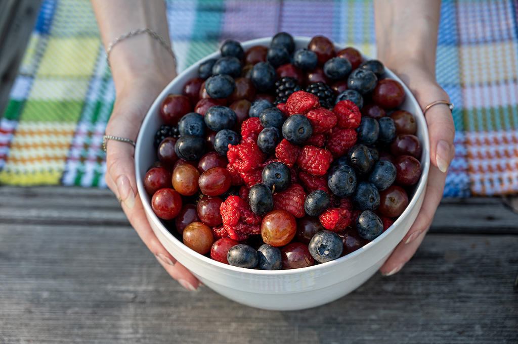 Large white bowl filled with various berries