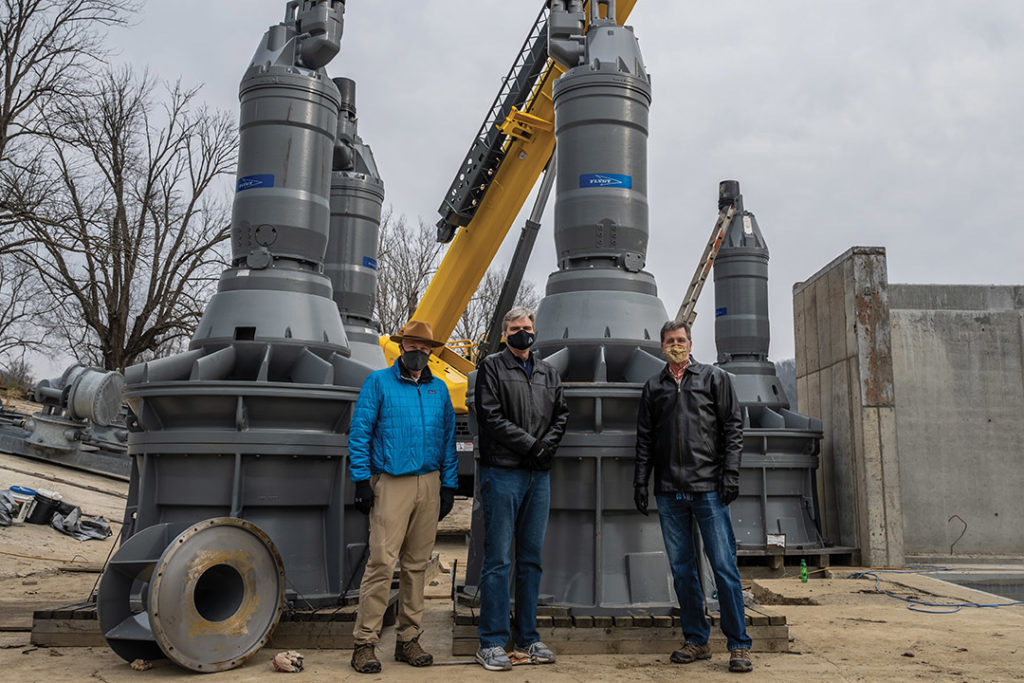 Judge Wilson, Derrick Singleton and Lyle Roelofs standing beside the turbine generators