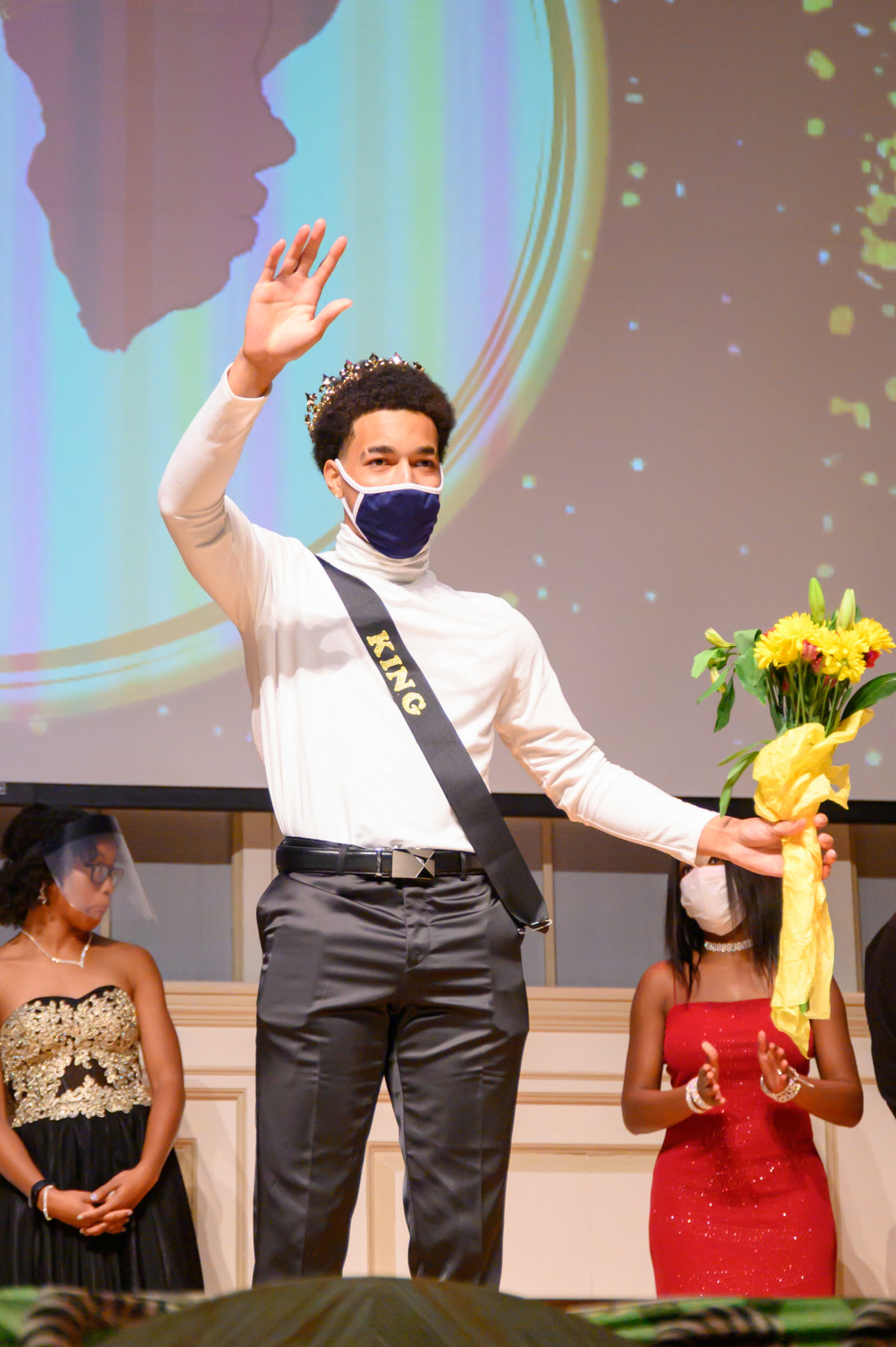 Black Student Union Pageant King waves to crowd
