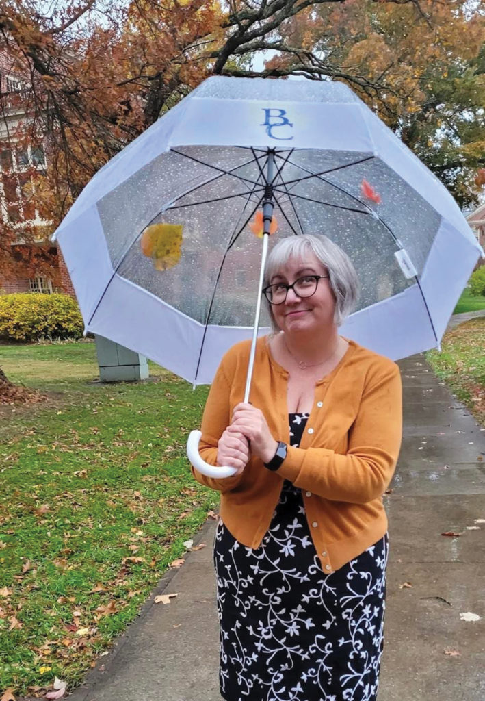 Photo of Amanda Peach holding an umbrella