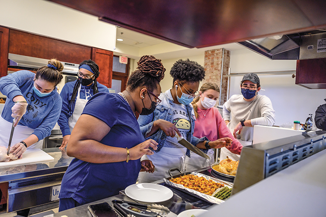 Jamilah Page in the CFS kitchen overseeing students preparing a meal