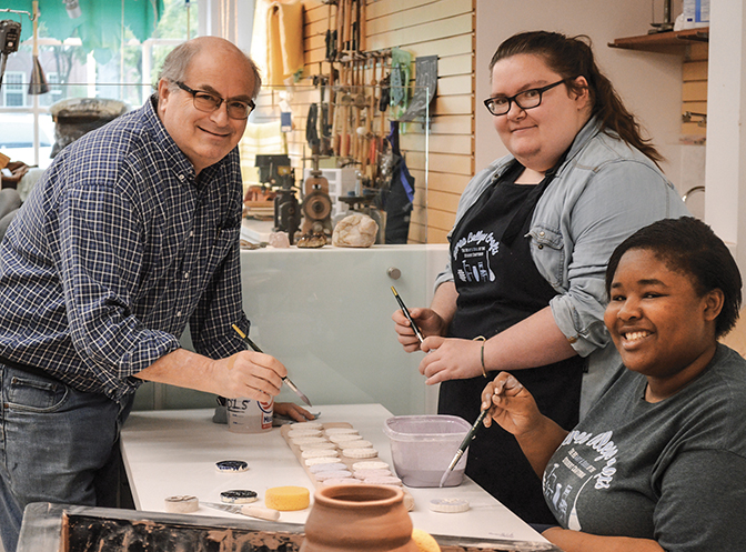 Photo of Steve Davis-Rosenbaum and two students demonstrating Craft in the Visitors Center and Shoppe