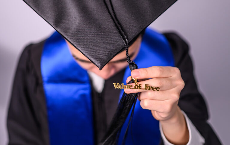 Picture of a student in a graduation cap with a tassel that says Value of Free