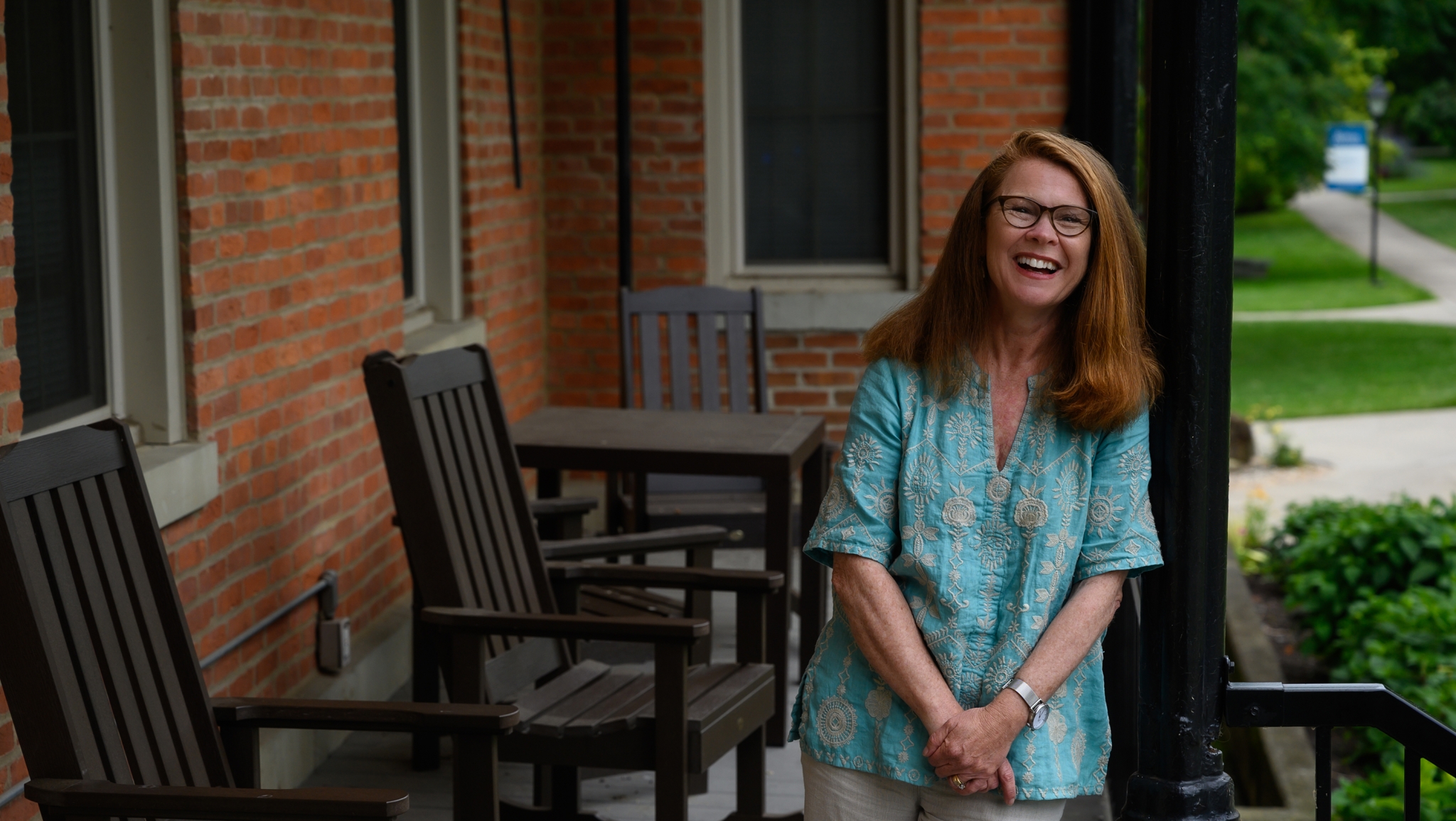 Portrait of Jodi Gentry on the porch of Fairchild Residence Hall