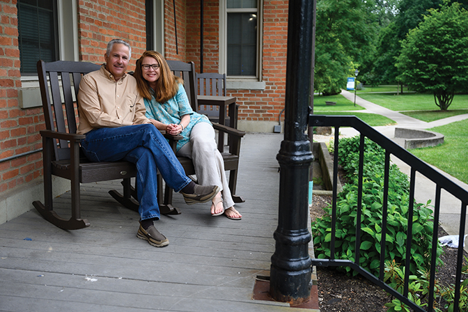 Portrait of Bradley Spatz and Jodi Gentry sitting on the porch of Fairchild Residence Hall