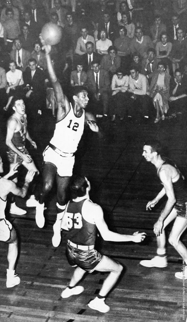 Historical black and white photo of Irvine Shanks shooting a basketball