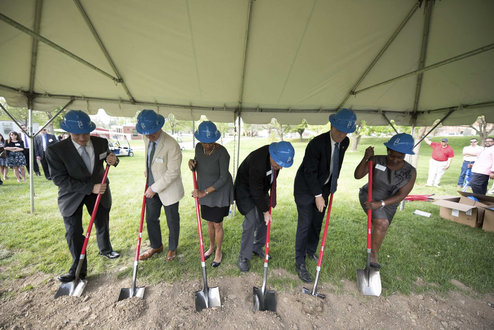 Photo of Trustess and College AC members breaking ground with shovels and hard hats