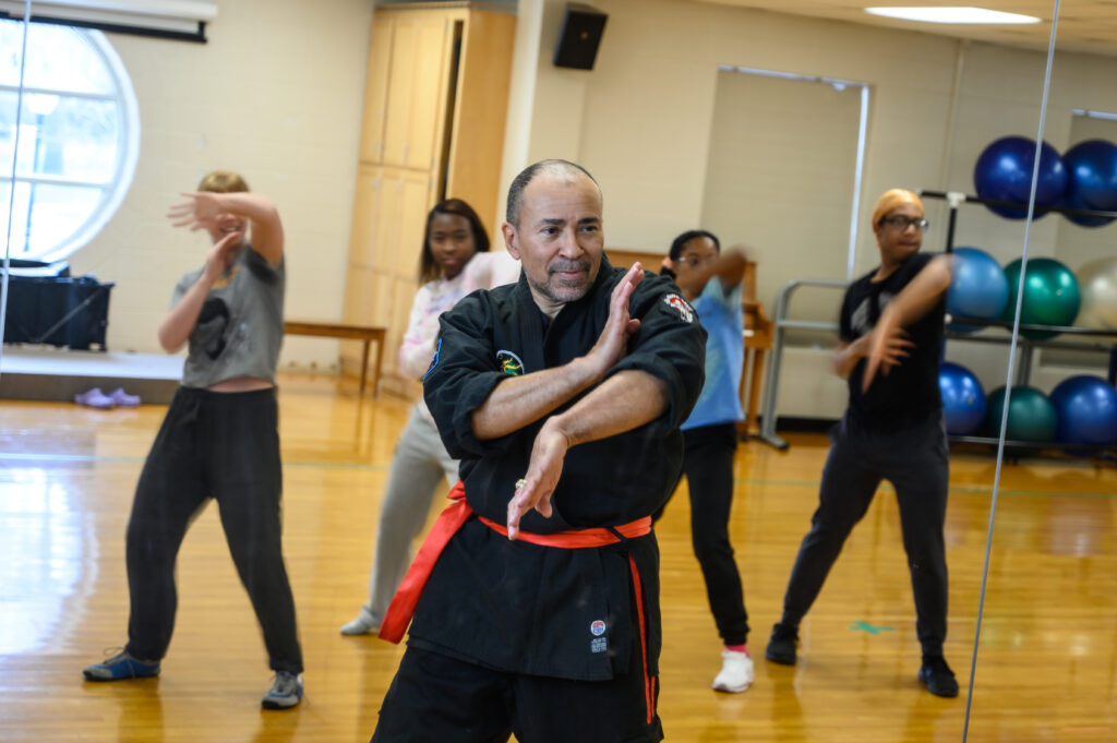 photo of Dr. Jose Pimienta-Bey teaching a martial arts class to students