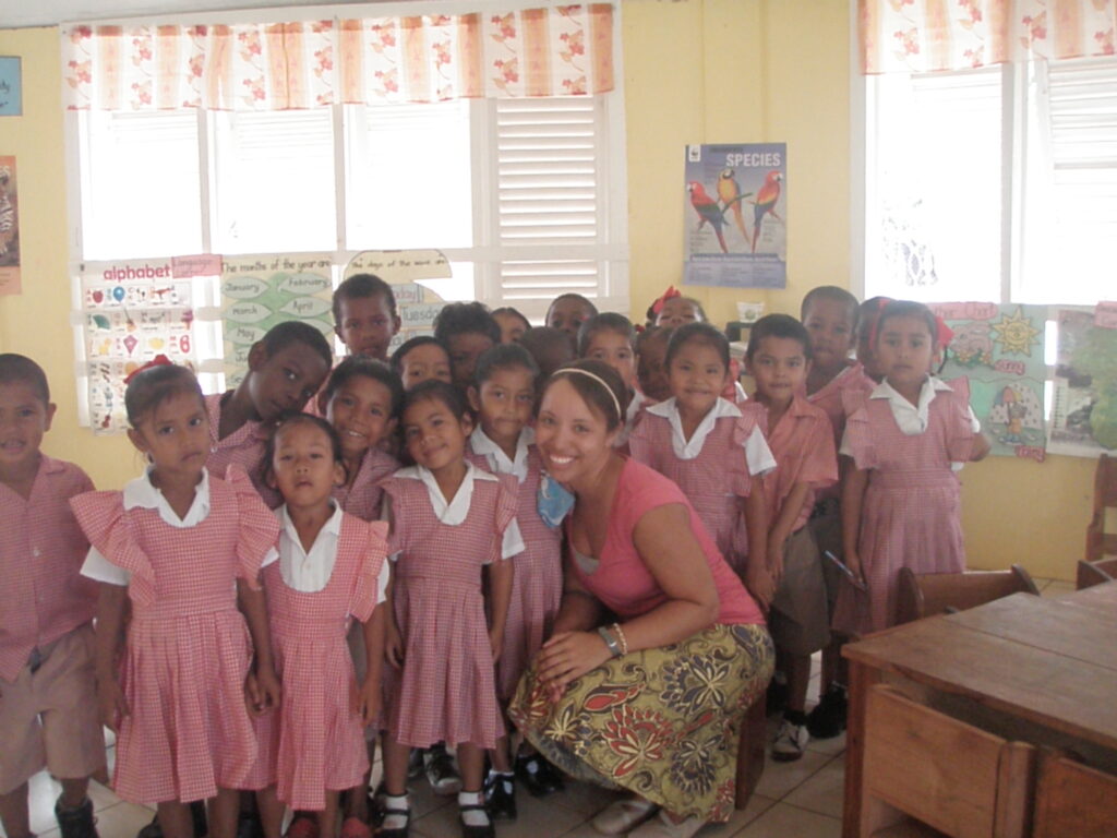 Princess Nash poses with students in a school in Guyana, South America. 