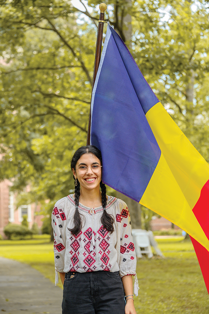 Ana-Maria ’26 stands with the Romanian flag as a celebration of All Peoples of the Earth Day.