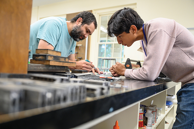 Berea professor helps student with a project in a lab.
