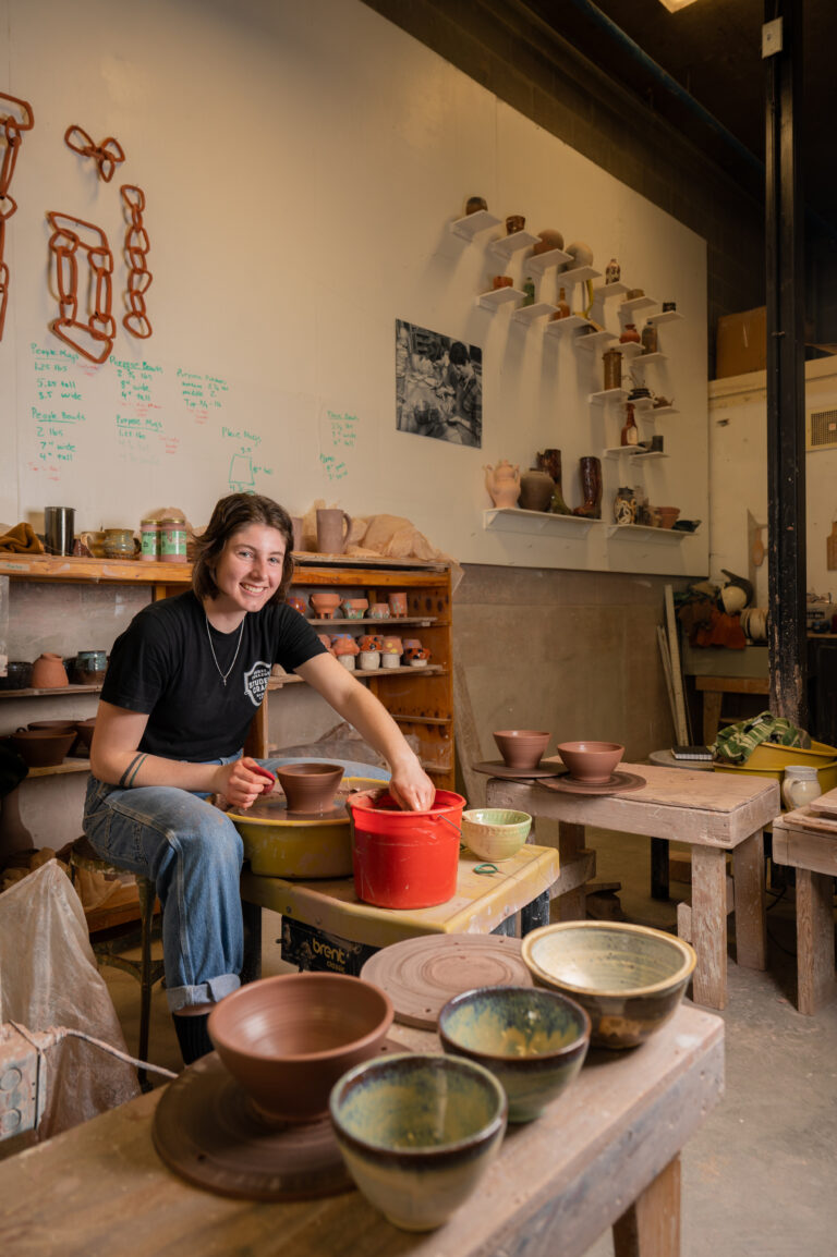 Ellen '24 throws a pot in the Ceramics Studio of Student Craft