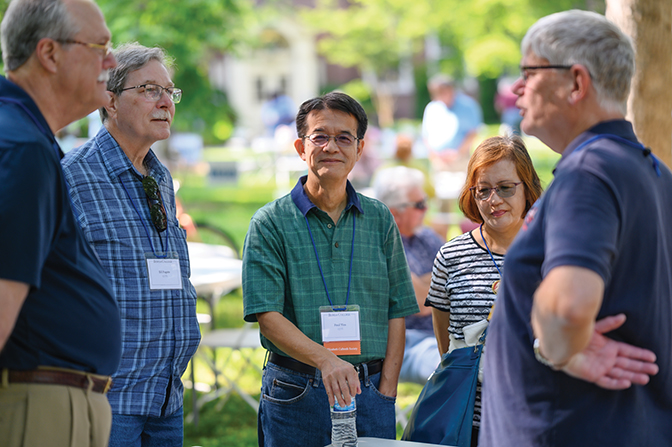 Alumni gather and catch up with one another during the picnic on the Quad. 