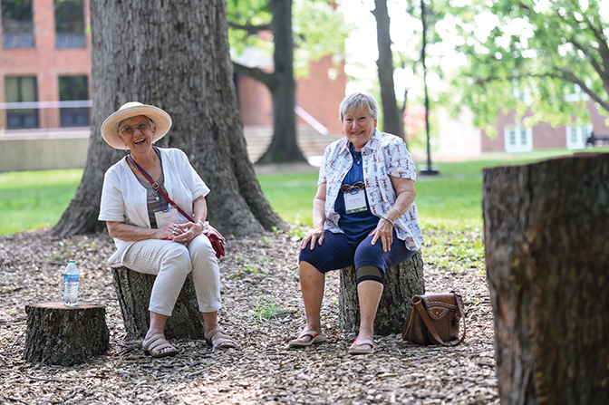 Joyce Hardy ’68 (left) and Betty Heanssler ’68 take a break and enjoy 
each other’s company during the picnic on the Quad. 