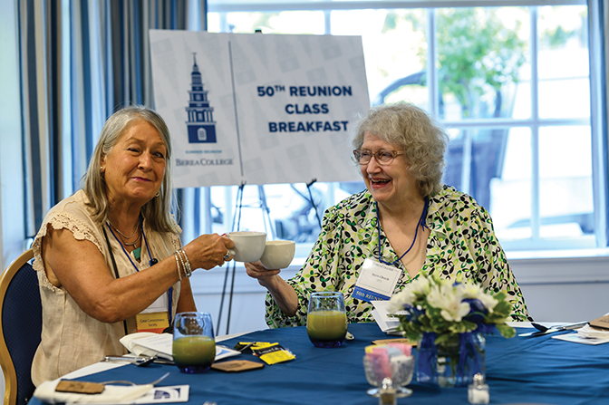 Earlene Prokopec ’73 and Joyce Church ’73 toast one another as they celebrate with their classmates at the 50th Reunion Breakfast.