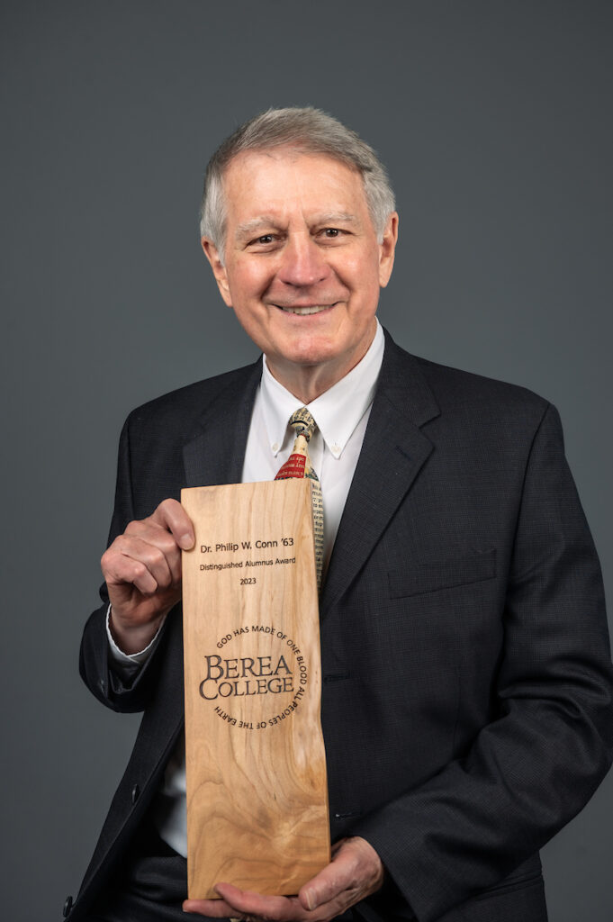Portrait of Philip W. Conn holding his Distinguished Alumnus award