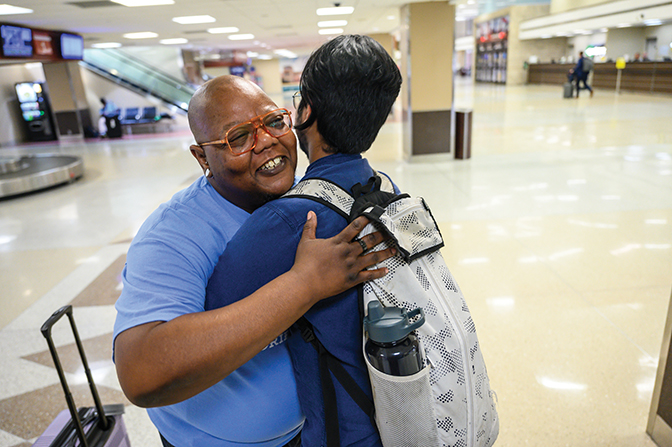 Kye Anderson greets an international student with a hug.