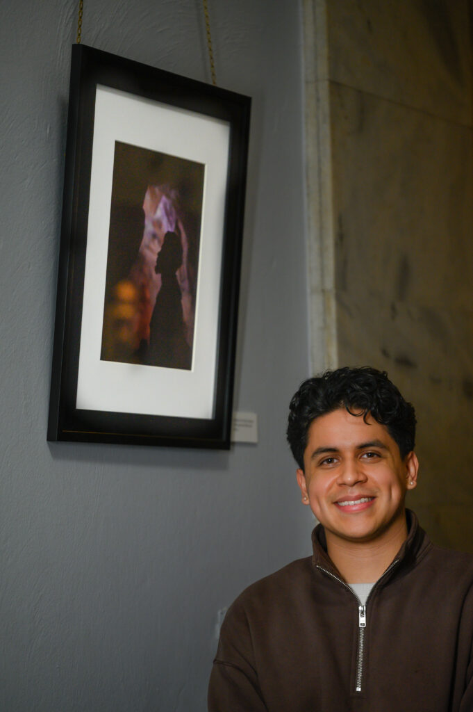 Portrait of Eduardo next to the picture displayed in the Capitol