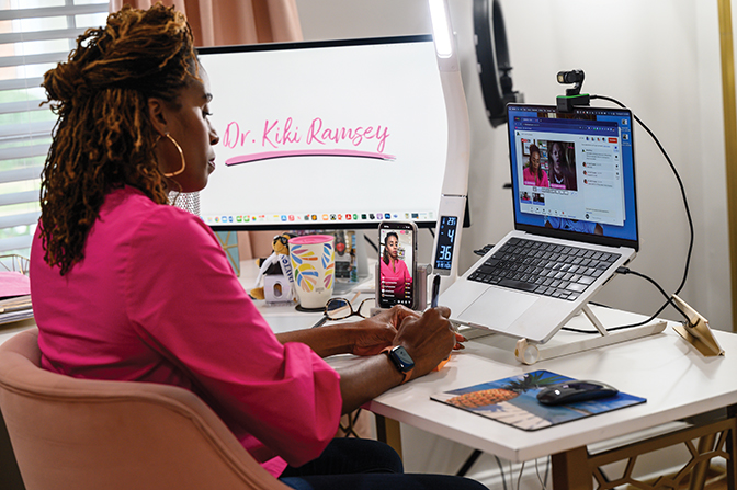 Kiki Ramsey at her home office participating in a podcast of the Dr. Kiki Ramsey show.
