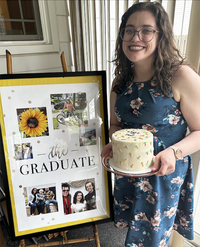 Picture of Amanda Luff holding a cake celebrating earning her Ph.D.