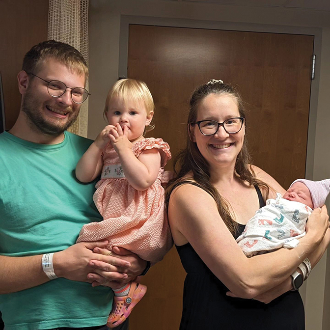 Photo of Cody and Mackenzie Vaugh holding their two children