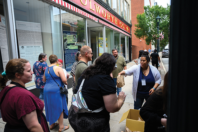 Image of Jessica Klanderud handing out lunches in front of Woolworth's, a historic Civil Rights site.