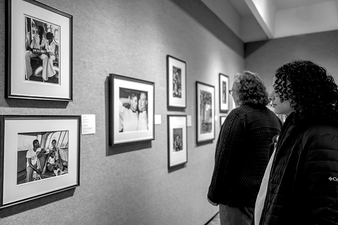 Visitors look at photographs in the upper gallery of the Doris Ulmann Galleries